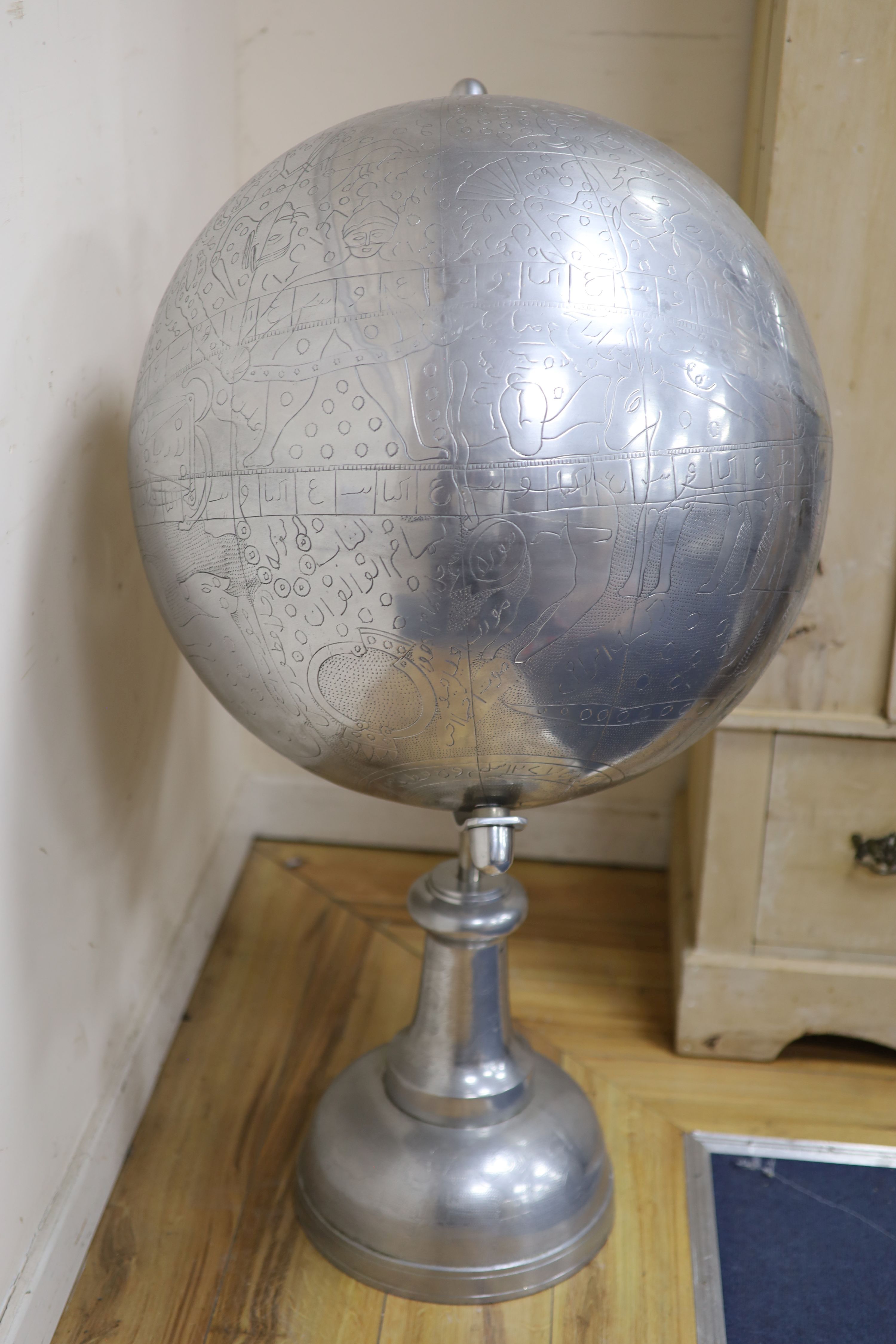 A large polished metal stylised celestial globe, retailed by Andrew Martin, H approx 110cm